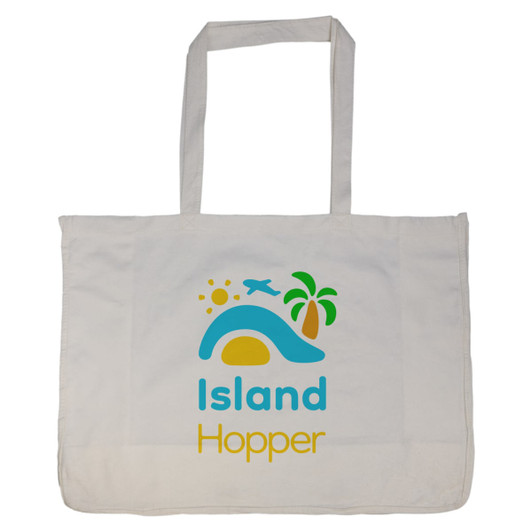 A large cream reusable grocery bag with blue and yellow designs featuring sun, palm tree, and airplane motifs.