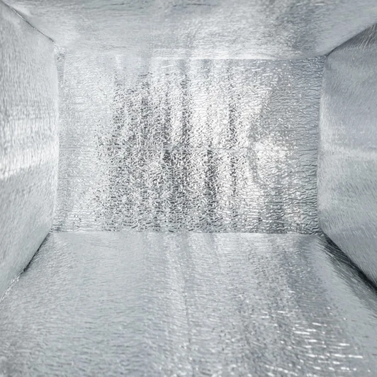 An insulated silver cooler bag interior with a shiny reflective surface and no visible contents.