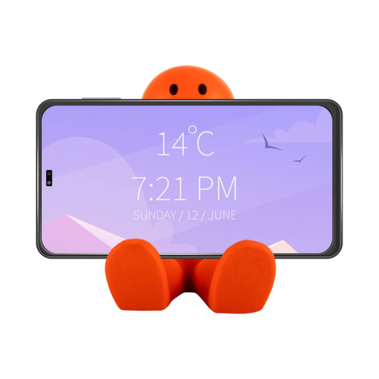 An orange stress reliever shaped like a seated figure, holding a smartphone in a vertical position.