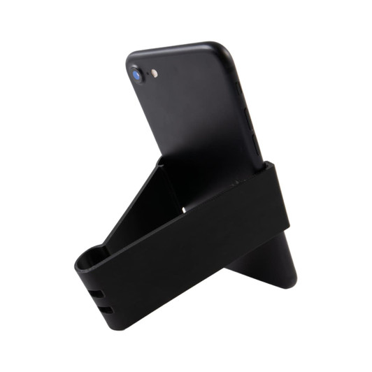 A black Grip Clip Phone Stand holds a smartphone in an upright position, featuring a sleek, minimalist design.