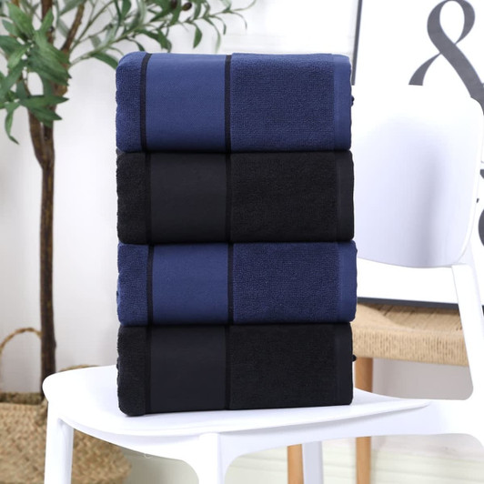 A stack of bath towels in dark blue and black, neatly folded on a white chair.