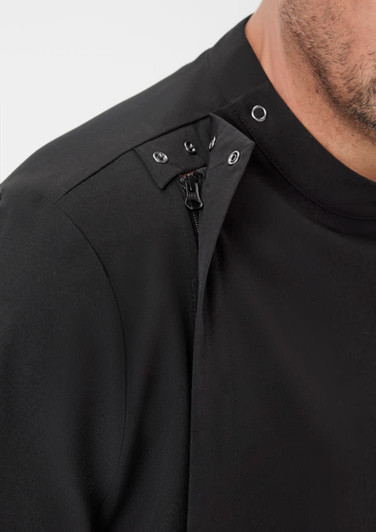 A close-up of a black men's jacket featuring snap buttons and a zip detail on the shoulder.