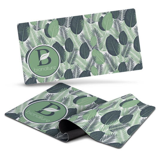 A desk mat featuring a leafy green design with various shades of green and a circular logo.