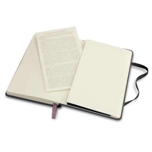 A Moleskine Classic hard cover notebook in black, featuring cream-coloured pages and a ribbon marker, opened to reveal a blank page.