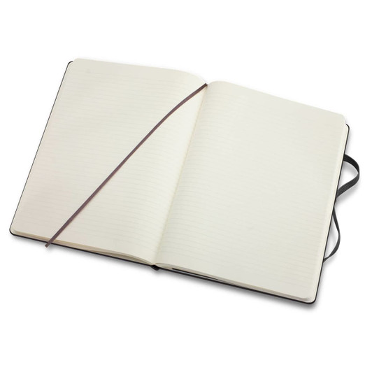 An extra large, black Moleskine classic hard cover notebook with blank lined pages, featuring an elastic band and ribbon bookmark.