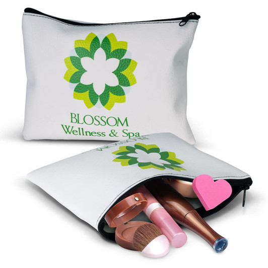 A small white cosmetic bag with a green floral logo, containing various makeup items like brushes and lip products.