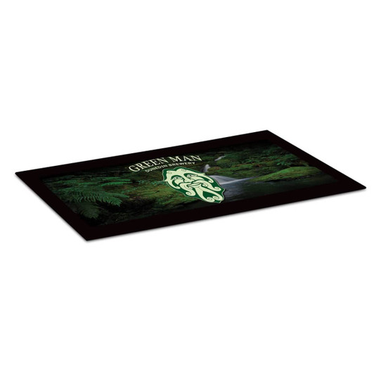 A small counter mat featuring a green design with a nature theme and a logo. The mat has a black border.