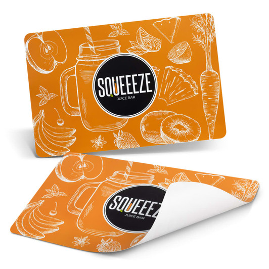 An orange place mat featuring hand-drawn fruits and vegetables with a logo.