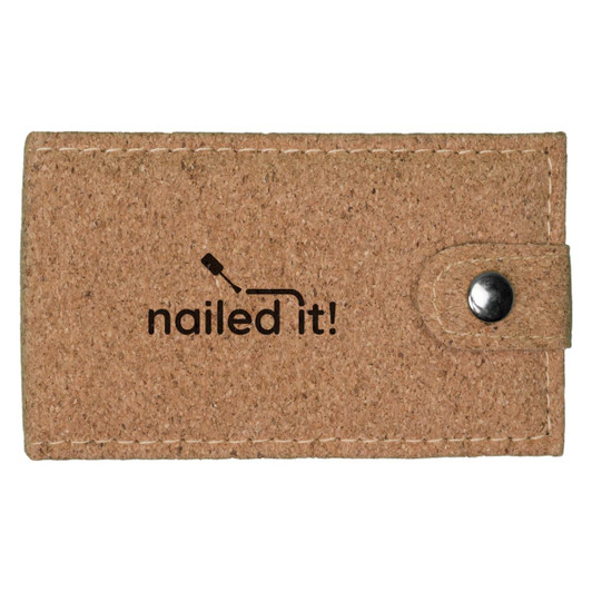 A cork manicure set in a beige case with a button closure and a logo printed on the front.