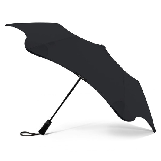 A black BLUNT Metro UV umbrella with a sleek, aerodynamic design, featuring a sturdy handle and a logo.