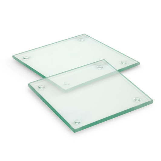 A set of two square glass coasters, featuring a clear finish with rounded corners and rubber feet for grip.