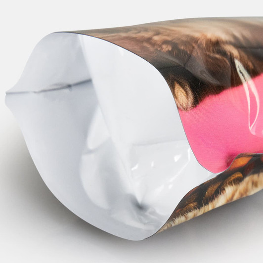 A foil stand-up pouch in vibrant pink and brown patterns, featuring a smooth, glossy finish and a hidden logo.