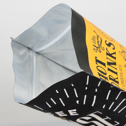 A large foil stand-up pouch with a black and yellow design and resealable top. Features a logo.