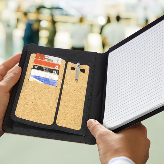 A cork portfolio in black featuring card slots, a pen holder, and lined paper.