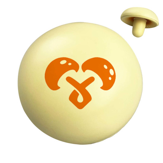 A yellow stress ball shaped like a mushroom, featuring an orange graphic on its surface and a smaller mushroom piece.