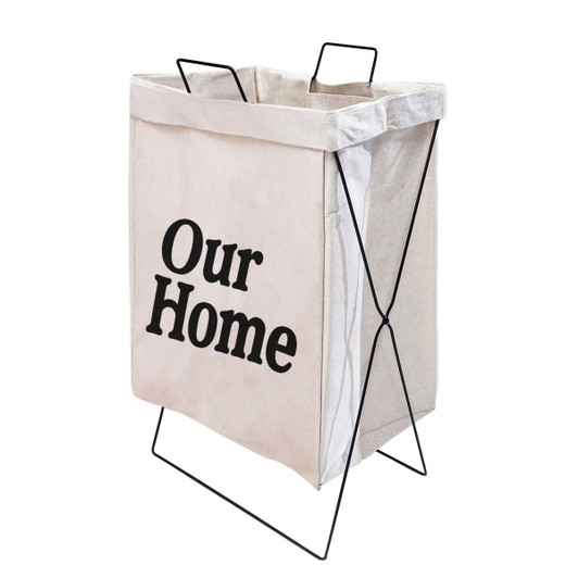 A beige cotton laundry basket with black text and a metal frame, featuring a simple modern design.