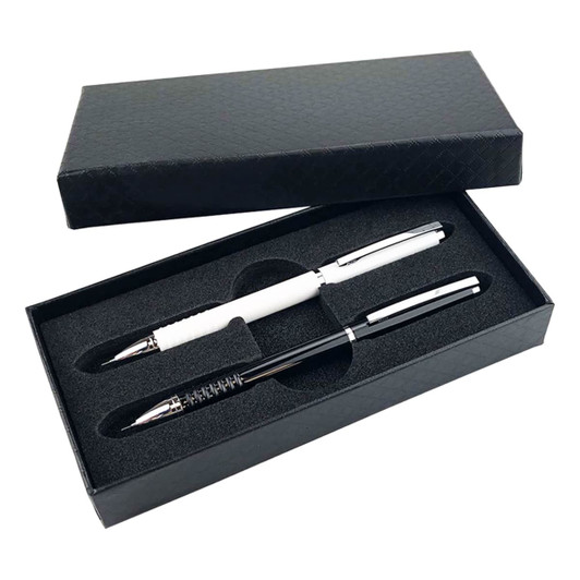 A gift box containing a black pen and a white pen, both with chrome accents, resting in black foam.