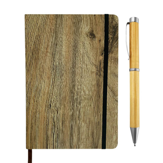 A wood look notebook with a black elastic band, next to a bamboo pen featuring a silver tip.