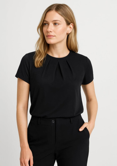 A black short sleeve top with pleated detailing, paired with tailored trousers and featuring a logo.