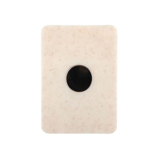 A creamy white magnetic clip with a circular black centre and a smooth, textured surface.