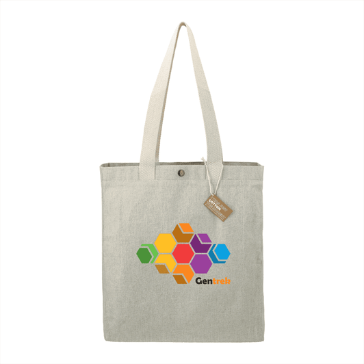 A light grey tote bag made from recycled cotton, featuring a colourful hexagonal design and a tag.