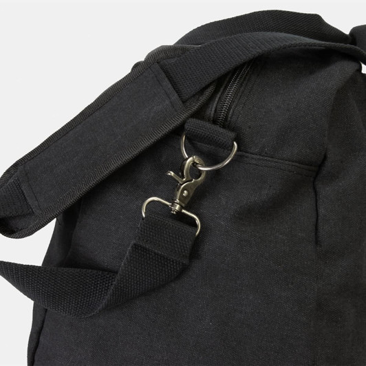 A black canvas duffle bag featuring a zipper and adjustable shoulder strap with a metal clasp.