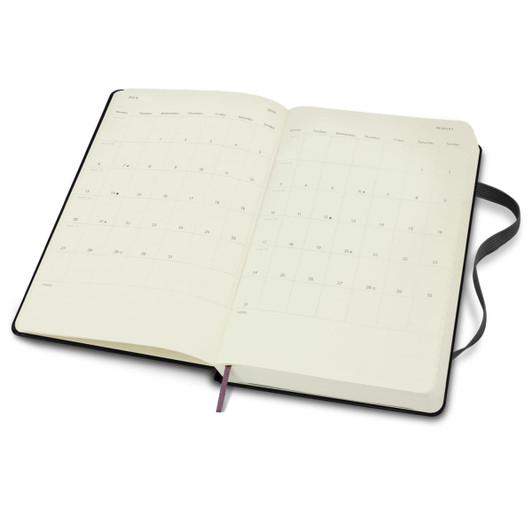 A black Moleskine 2026 Daily Planner, open to show blank pages with a ribbon bookmark.