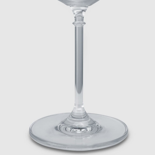 A clear glass gin glass featuring a slender stem and wide base, elegantly designed for serving beverages.
