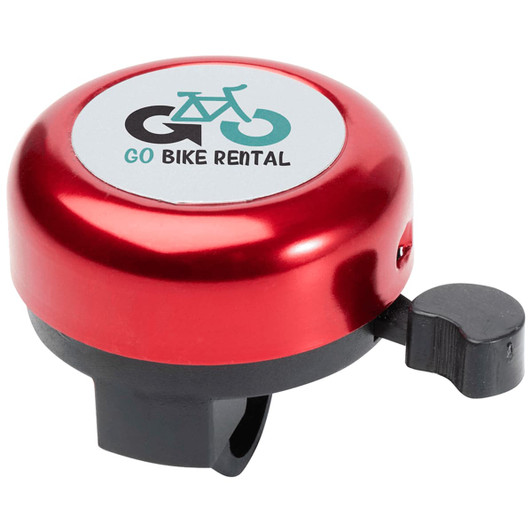 A red bicycle bell with a black base and a lever, featuring a logo on a white circle.