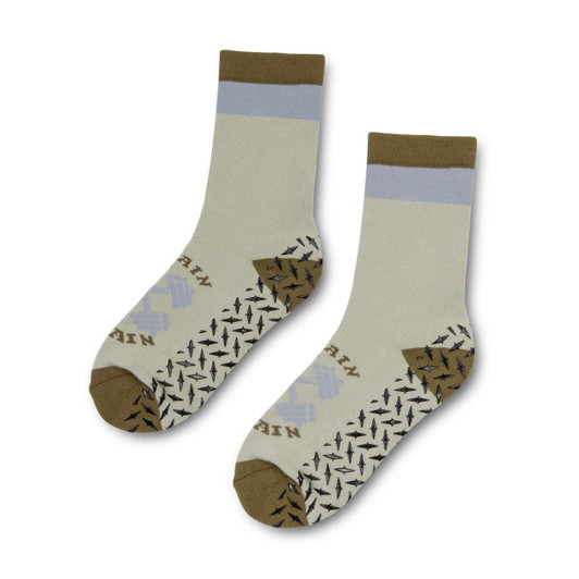 A pair of Nero Crew Grip Socks in light green, brown, and blue, featuring a pattern on the soles and a logo.