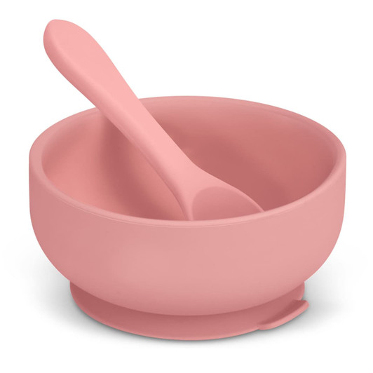 A pink suction bowl set for kids, including a matching spoon, designed for stable use on surfaces.