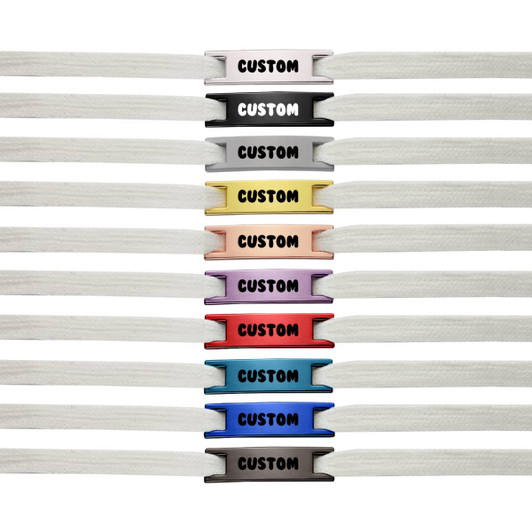 A row of white shoelaces with various coloured charms, featuring a logo and the word "CUSTOM" on each charm.