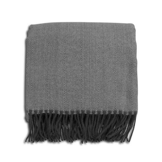 A grey herringbone throw blanket with fringe detailing, neatly folded. It has a subtle pattern and a soft texture.