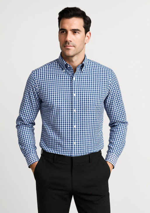 A blue and white checked long sleeve button-up shirt featuring a collar and a logo. The model stands with hands in pockets.
