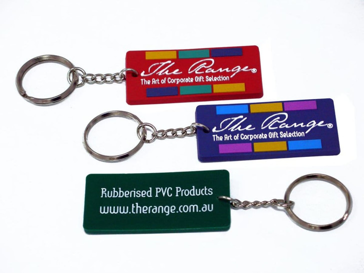 A set of three custom PVC keyrings in red, purple, and green, featuring a metal chain and keyring attachment.