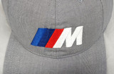 Embroidered ///M logo contrasts well with this gray twill cap.