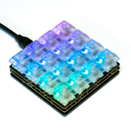 Pimoroni Keybow 2040 Clicky Keys macro pad with 16 RGB backlit mechanical switches and clear keycaps. Pimoroni Keybow 2040 Clicky Keys macro pad with 16 RGB backlit mechanical switches and clear keycaps.