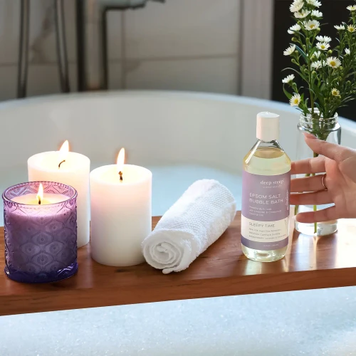 Lifestyle image of Deep Steep Sleepy Time Epsom Salt Calming Sleep Bubble Bath 10oz in a bathtub setting.