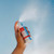 Trifecta Power Mist in a hand showing the pump mist that dispenses.
