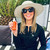 Lifestyle image of Tricia holding the Milky Mineral Sun Serum Spray at the Pool (with proper sunscreen measures including Sun hat, glasses and UV Shirt).