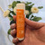 Lifestyle image of new Suntegrity Mineral SPORT Sun Stick, SPF 30 - 17g in a hand with a plant behind.