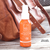 Suntegrity Milky Mineral Sun Serum Spray, Broad Spectrum SPF 50 Lifestyle image with handbag on deck. Photo Credit: SirenWilliams