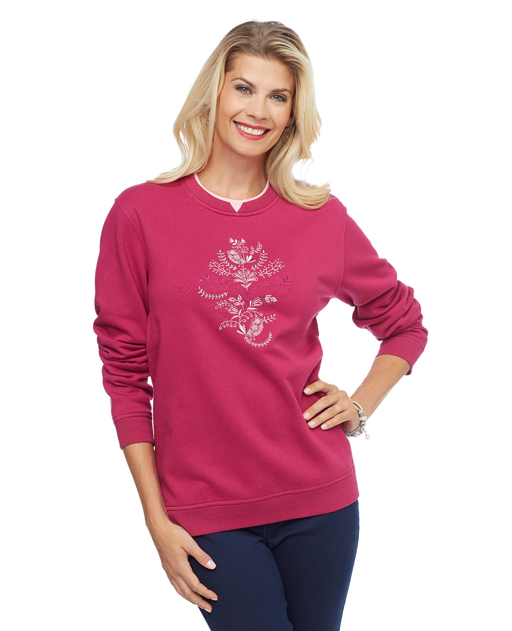 Woman in magenta pullover sweater with bird applique