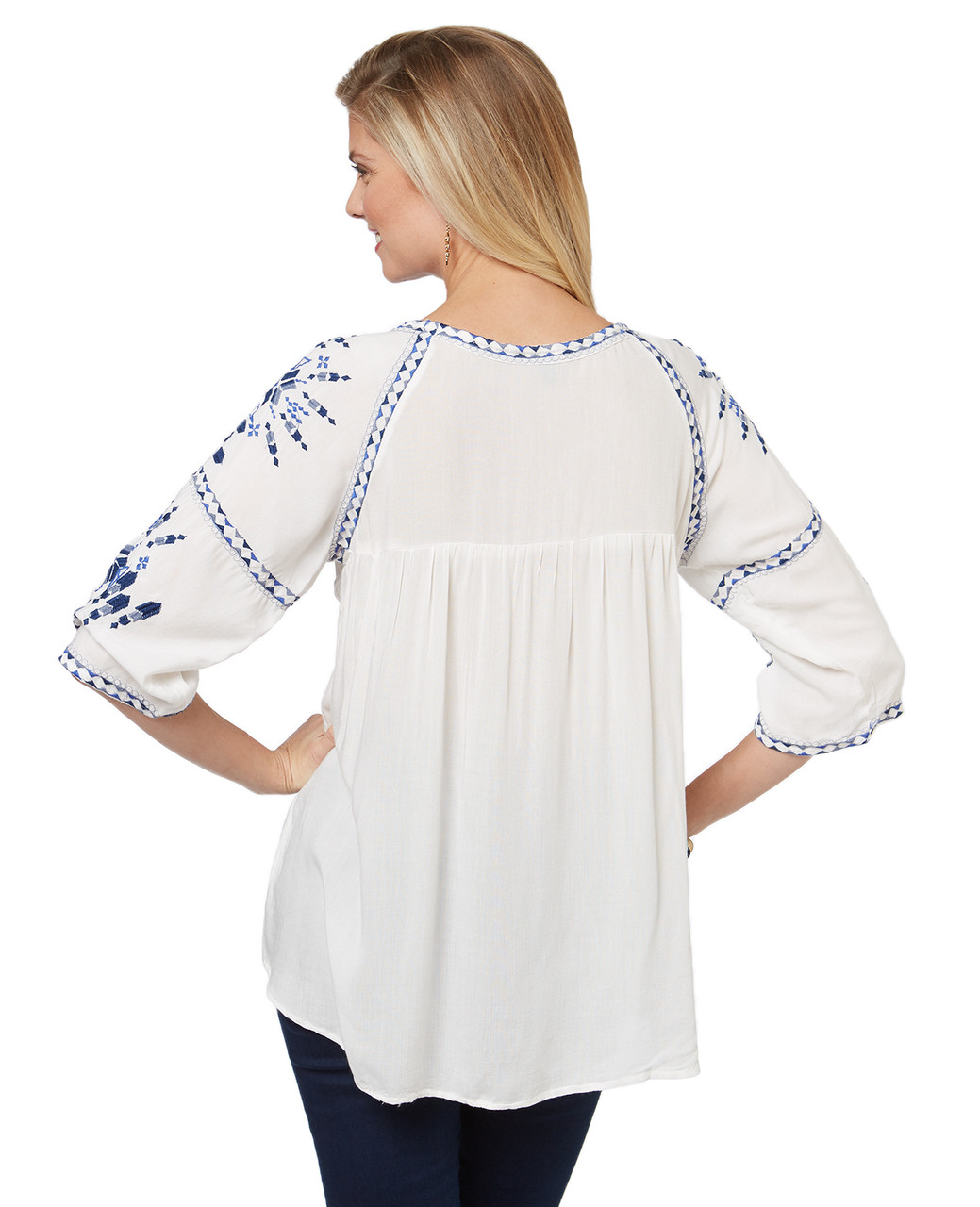 Women's white top in peasant blouse style. Embroidered with tassel feature.