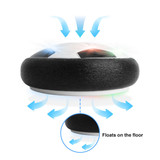 A hover soccer ball with a black and white design, featuring a logo, that floats on the floor.