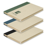 A stack of three Paulo Sugarcane Notebooks in green, blue, and black, with a logo on the cover.