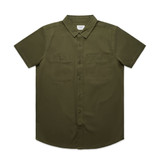 An olive green short-sleeve shirt featuring two chest pockets and a collar, with a logo on the tag.