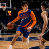 A sports uniform featuring a blue and orange long-sleeve shirt with a logo, worn during a basketball game.