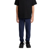 Track pants in navy blue worn by a person in black sneakers and a black t-shirt. The pants have a simple design.