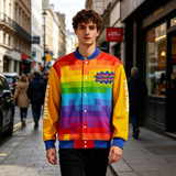 A vibrant unisex polyester spandex track jacket featuring rainbow colours and a logo, set in an urban street scene.